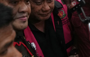 Dadan Hindayana is escorted by prosecutors in Jakarta