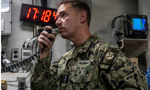 Brad Cooper, head of the US Central Command, makes an announcement aboard the Nimitz-class aircraft