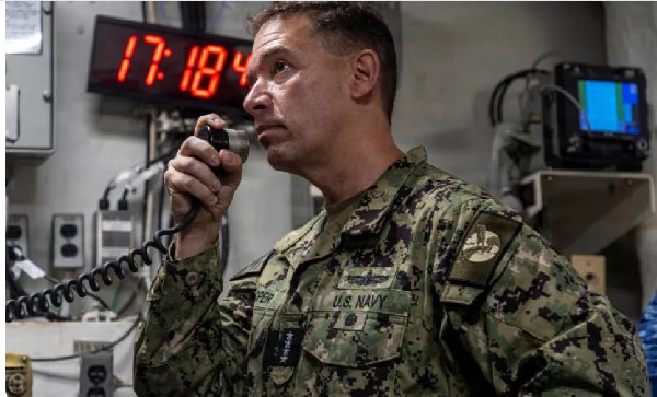 Brad Cooper, head of the US Central Command, makes an announcement aboard the Nimitz-class aircraft