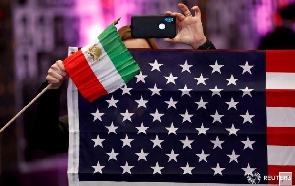 Attendees hold flags from Iran and the United States, REUTERS/ Patrick T. Fallon/File Photo