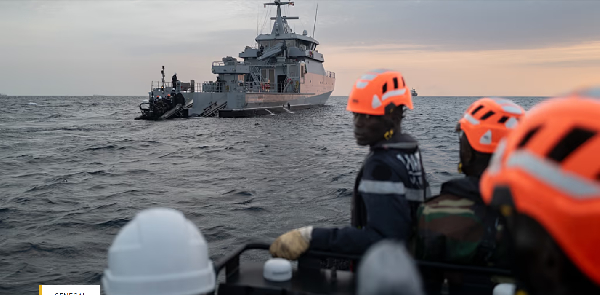 Senegalese sailors approach a fishing canoe during a mission to search for migrant boats near the co