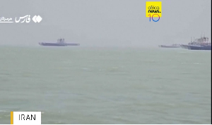 Cargo ships are seen at sea near the Strait of Hormuz