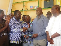 Dr. Philip K. Amoo in a handshake with ASP Joseph Kaguah