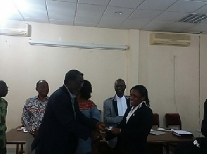 A female referee receiving her FIFA badges at the GFA Secretariat
