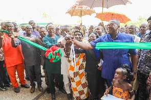Dr. Ben K. D. Asante cutting the ribbon for the commissioning of the project