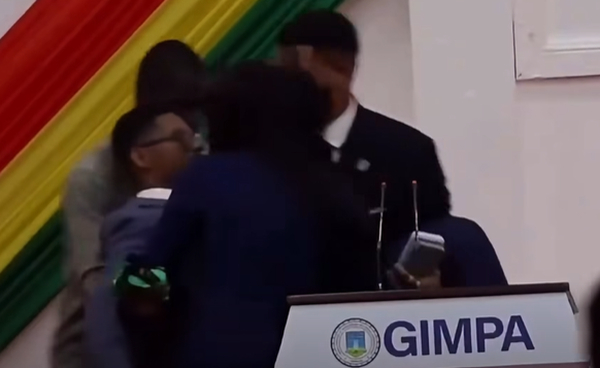 Screenshot from a video showing MP Francis-Xavier Sosu being carried from the stage
