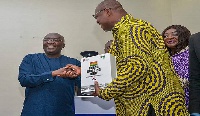 Rev. Dr. Dawson-Ahmoah receives a copy of the Building code on behalf of CMAG from Dr. Bawumia