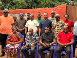 Volta YEA director in a group photograph with family of the deceased
