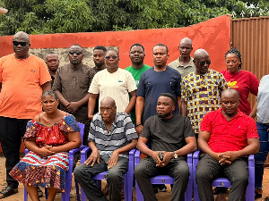 Volta YEA director in a group photograph with family of the deceased