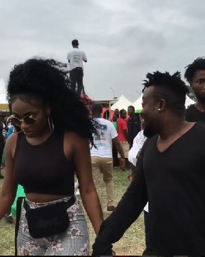 Wendy Shay holding hands with her manager Bullet at the El-Wak Sports Stadium in Accra