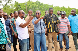 The minister with some leaders on one of the farms