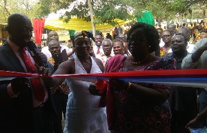 The MP with Mrs. Veronica Adzato-Ntem cutting the tape to open a new facility