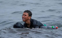 Moroccan boys swim from the Moroccan border town of Fnideq toward the Spanish enclave of Ceuta