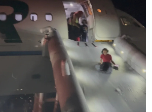 Passengers evacuate the Frontier Airlines plane that struck a pedestrian Friday in Denver