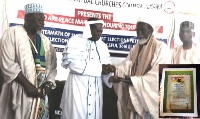 prophet N'akoa Nazareth Ansah Jamson (2nd L) presenting citation to Shiekh Shaributu.