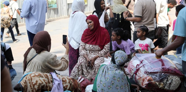 Sudanese nationals wait to enter Ramses railway station in Cairo, Egypt, ahead of their return