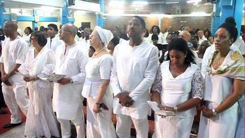 The family clad in white at the memorial service of the late Jake Obetsebi Lamptey