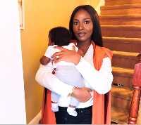 Mrs. Dumelo carrying her son
