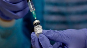 A medical health worker fills a syringe with the Covid-19 vaccine at Clalit Health Services center