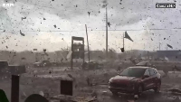 Screenshot from a video of a tornado causing havoc