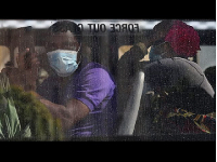 Foreign migrants board a bus after evacuation in Cape Town