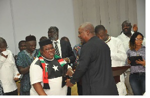 Jewel Ackah in a handshake with former President Mahama