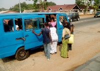 Some commuters boarding a Trotro