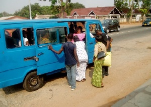 Some commuters boarding a Trotro