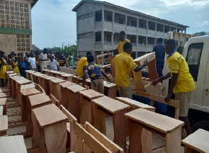 Photos of students taking delivery of the desks