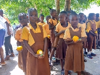 School pupils with oranges donated to them