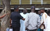 Daniel Nii Kwartei Titus-Glover being restrained by the police commander