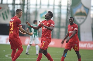 Asamoah Gyan joins a colleague celebrate a goal
