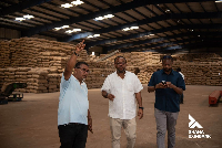 A photo of Moses Klu engaging with officials at Nadkansco Processing Limited
