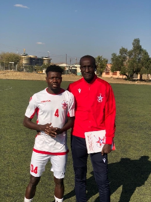 Coach Prince Koffie with one of the players