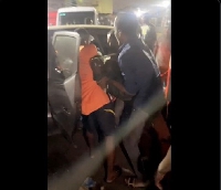 Man being carried into a cab at Lapaz