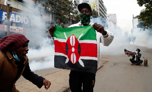 Protesters hold flags during an antigovernment demonstration in Kenya's capital