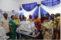 Officials of Newmont, health workers and chiefs of Abirim in a group photograph with the incubator