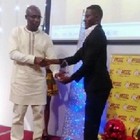 Adams receiving his award from George Afriyie