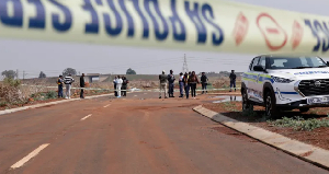 South African police and pathologists inspect the body of a woman found on the side of a road South African police and pathologists inspect the body of a woman found on the side of a road