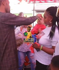 Rev Obofour spraying money on his one year old son