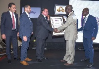 Board chairman for Ghana Standards Authority, Kwesi Acheampong presenting a certificate to Dr Deraz