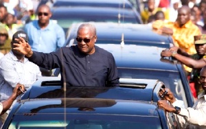 President John Mahama waves from car.     File photo.