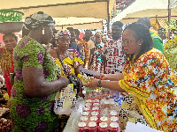 MP for Shai Osudoku (right) presenting Christmas 'freebies' to branch executives.