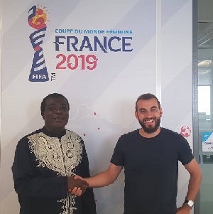 Sarfo (L) in a handshake with Benoit Boisson at the FIFA Headquarters in Paris earlier this month