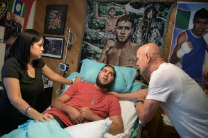 Nieves Melendez and Richard Colon tend to Prichard Colon at home