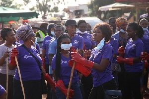 Some female staff of Jospong group cheerfully cleaning up the market