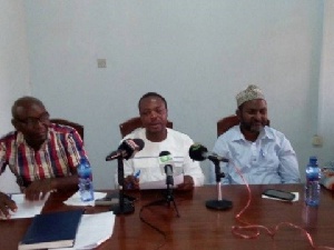 Charles Nyaaba (middle) reading the statement
