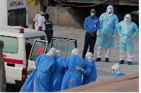 Health workers in protective gear evacuate patients from  MV Hondius cruise ship into an ambulance