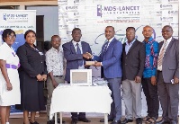 Dr. Paul S-Nyantakyi of MDS-Lancet Lab handing over the cardiac monitor to Dr. Oheneba Danso of KATH