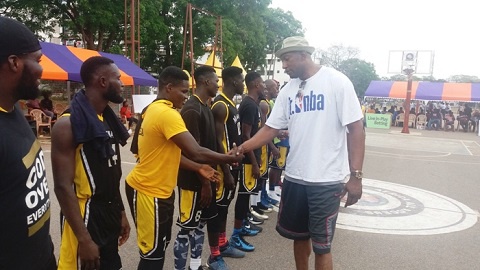 Didier Mbenga in a handshake with Marshalls players before their game